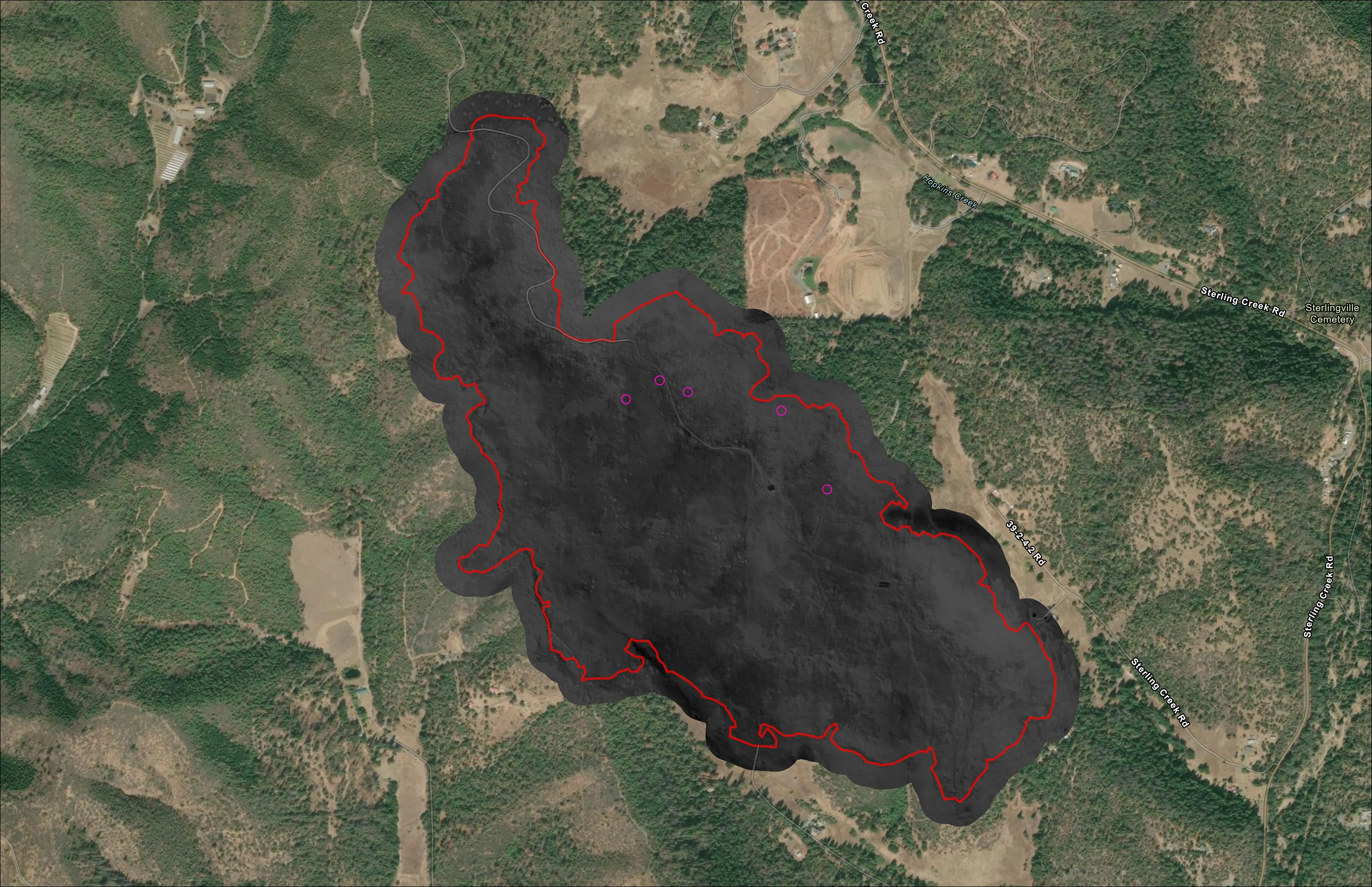 Night infrared orthomosaic of a wildland fire: the heat perimeter outlined in red over dark terrain, with faint heat signatures inside the line.
