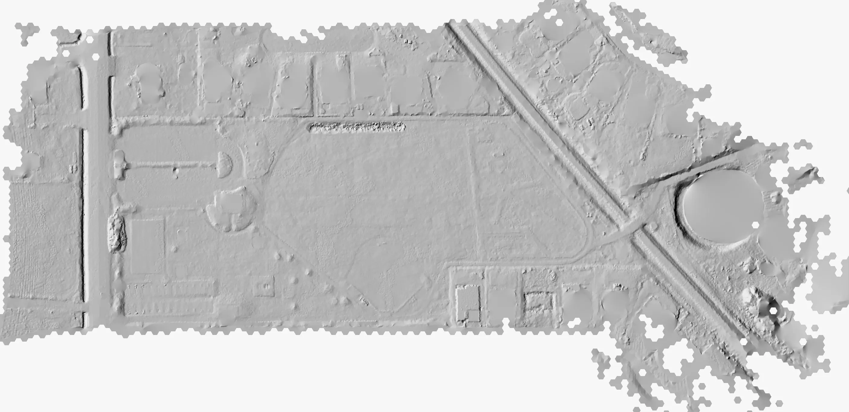 Bare earth hillshade of a city park: paths, ball fields, and a roofed structure at the east end in relief.